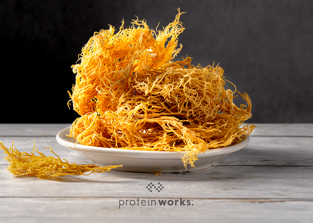 Bundle of Irish Sea Moss on a white plate with a black background